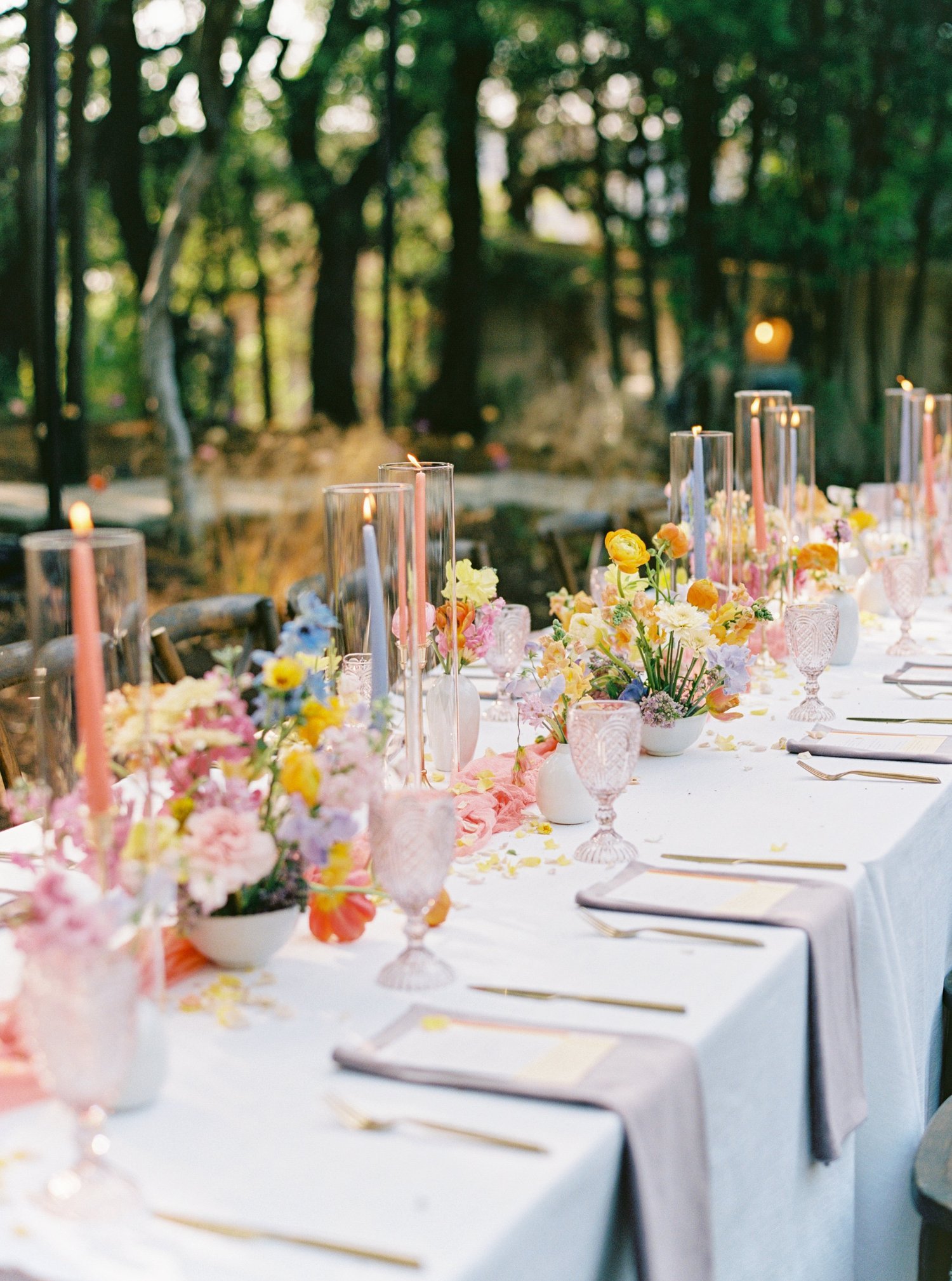 Colorful spring reception tablescape with taper candles
