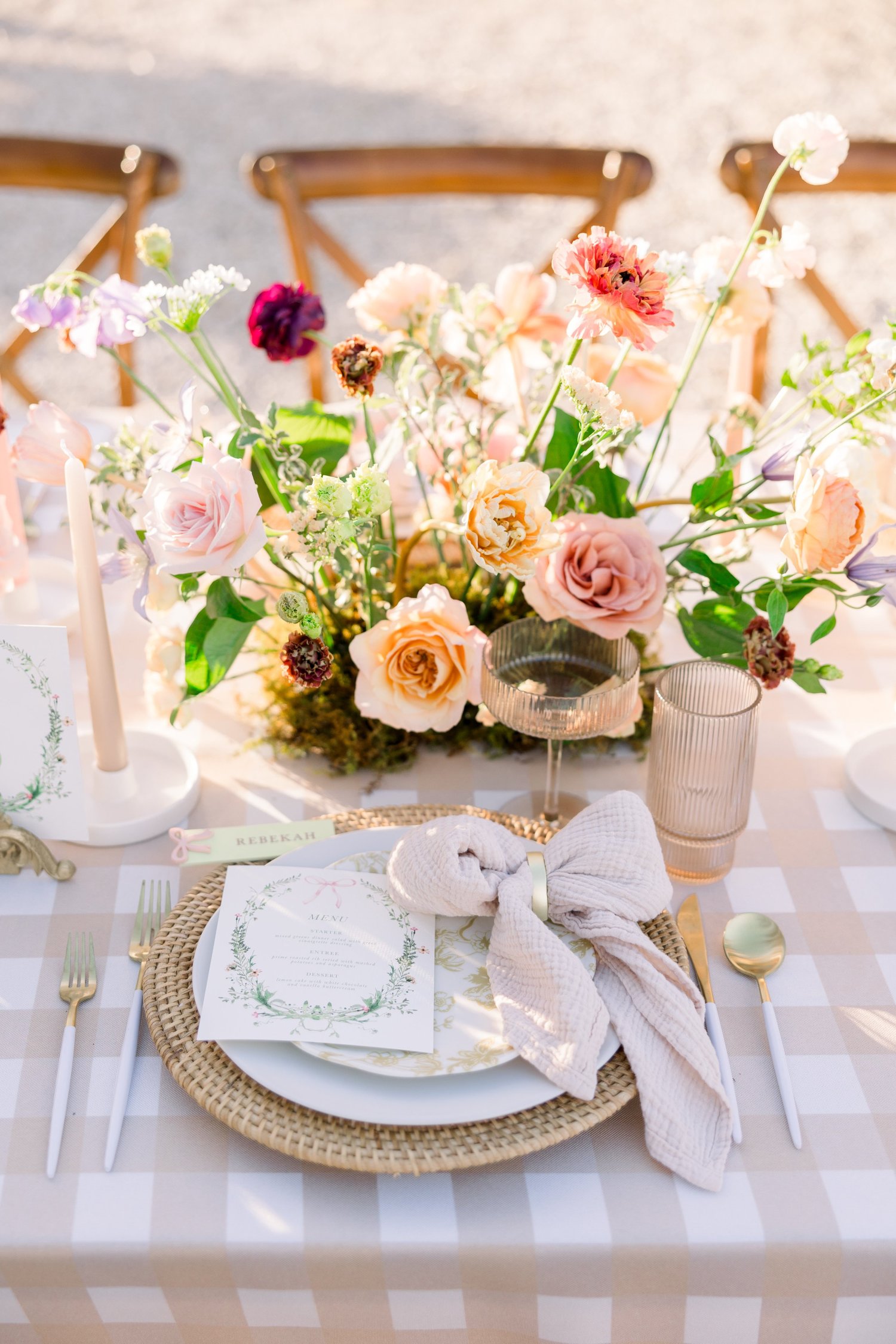 Peach and rose centerpiece at a styled place setting