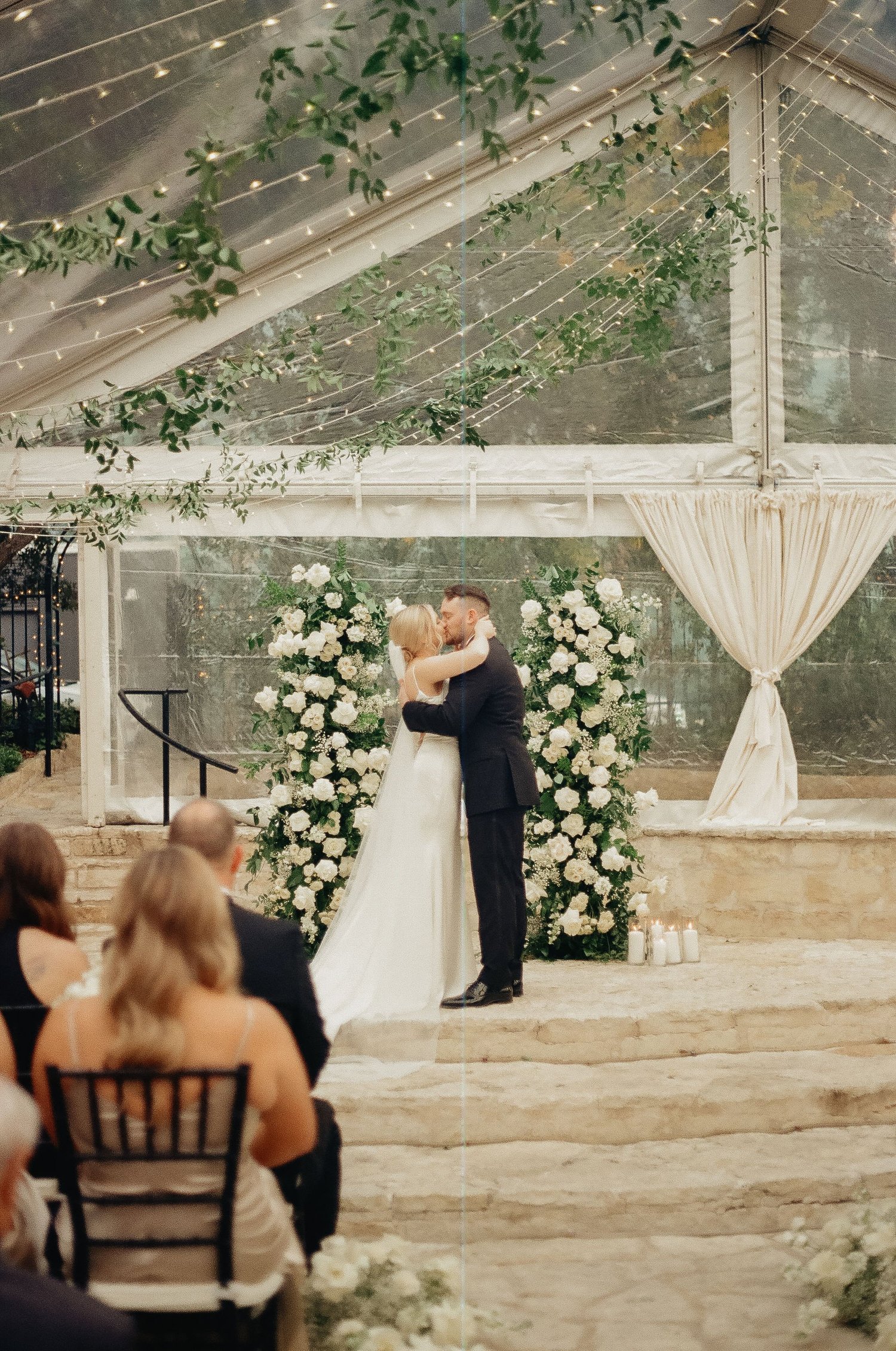 Greenhouse ceremony with a white-and-greenery altar